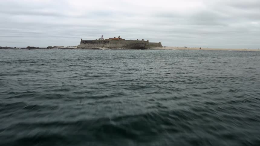 An island in the ocean with a large cliff on it