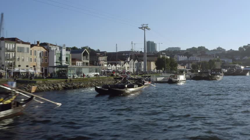 Boats docked along a waterway in a city on a sunny day