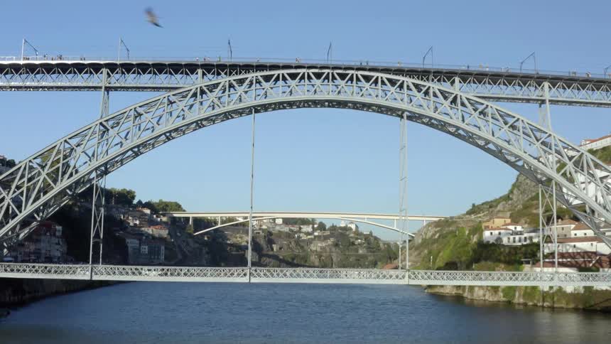 Aerial view of people going over arch bridges over river