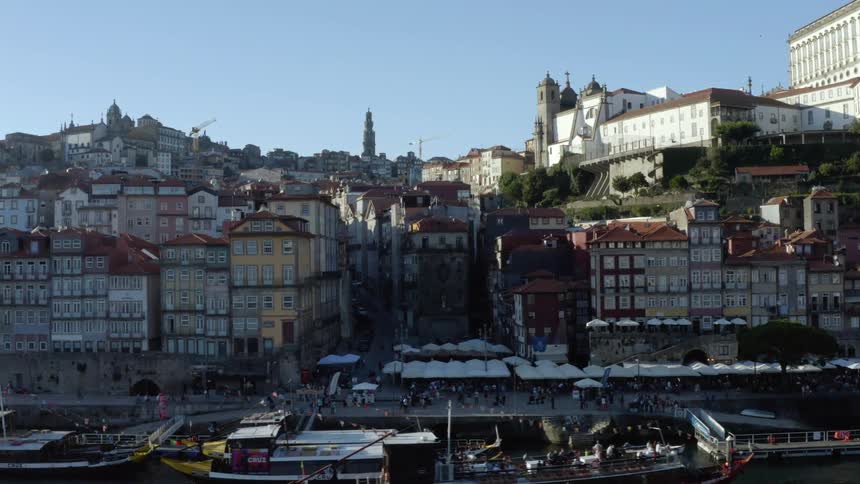 Buildings are stacked close together in a city along the coast