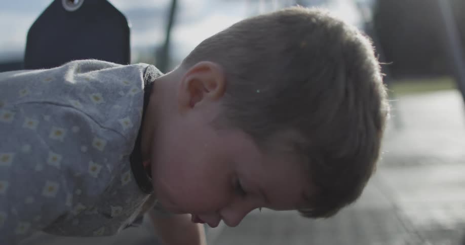 A boy playing on a swing