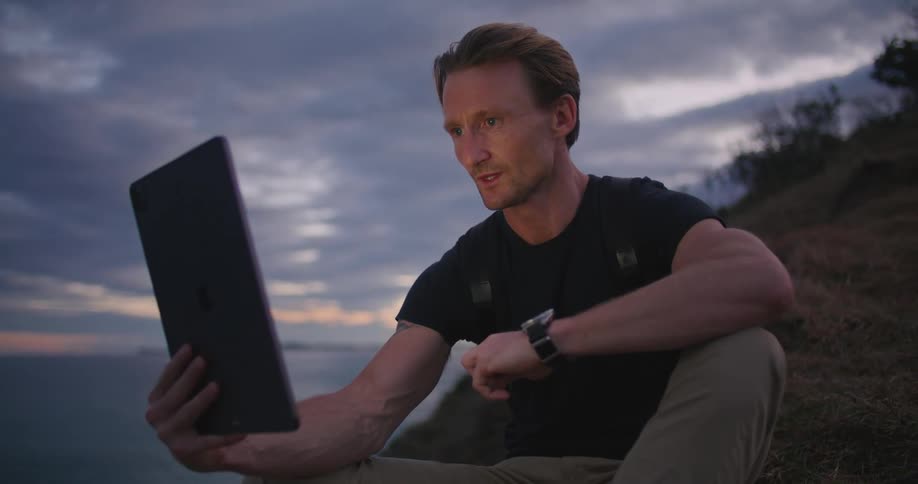 A man sitting and talking on a video call on a tablet
