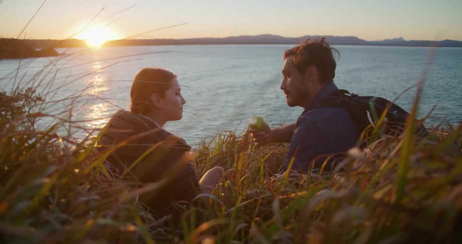 A view of a man and woman sitting outdoors talking