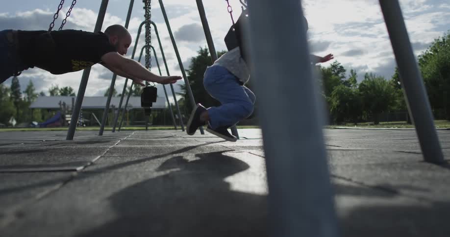 Father and son swinging as superhero