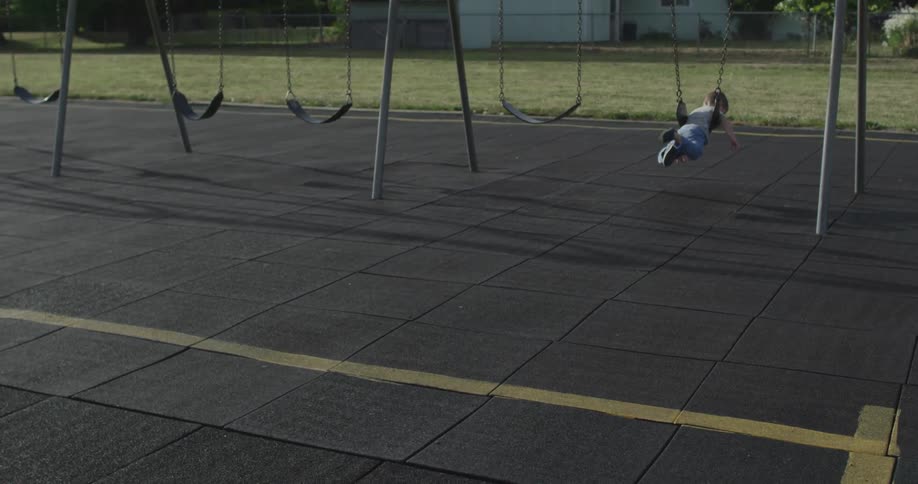 A boy gets on a swing
