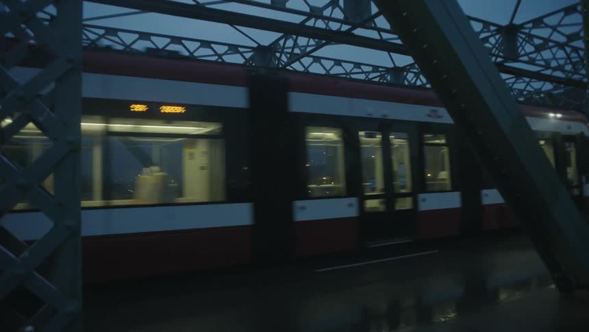 A car follows a train over the bridge