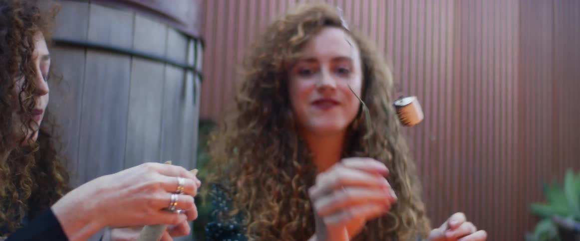 Two women eating smores outdoors