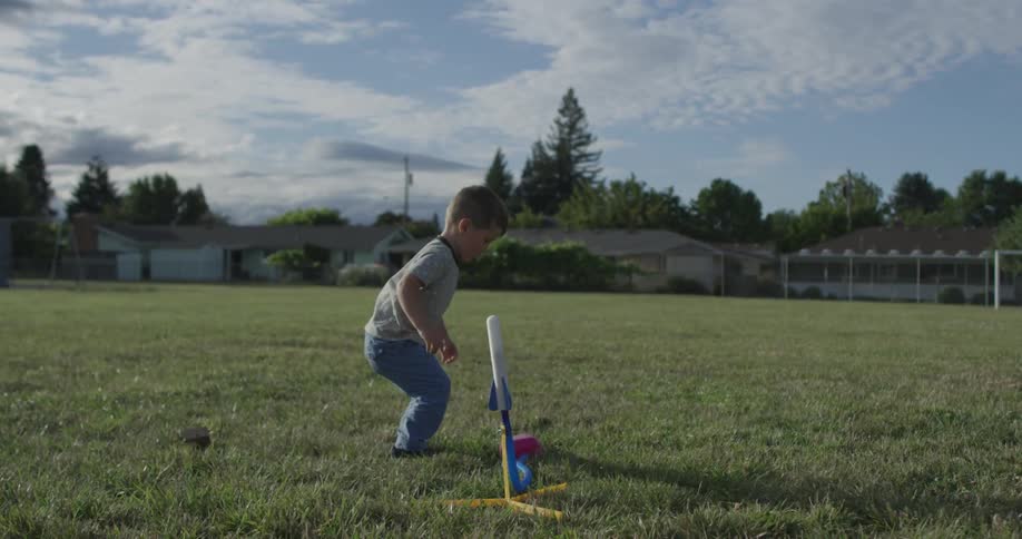 A boy jumps on the lever of a toy rocket shooting it into the air