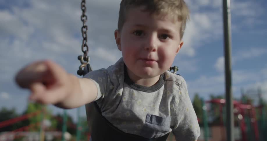 A boy plays on a swing