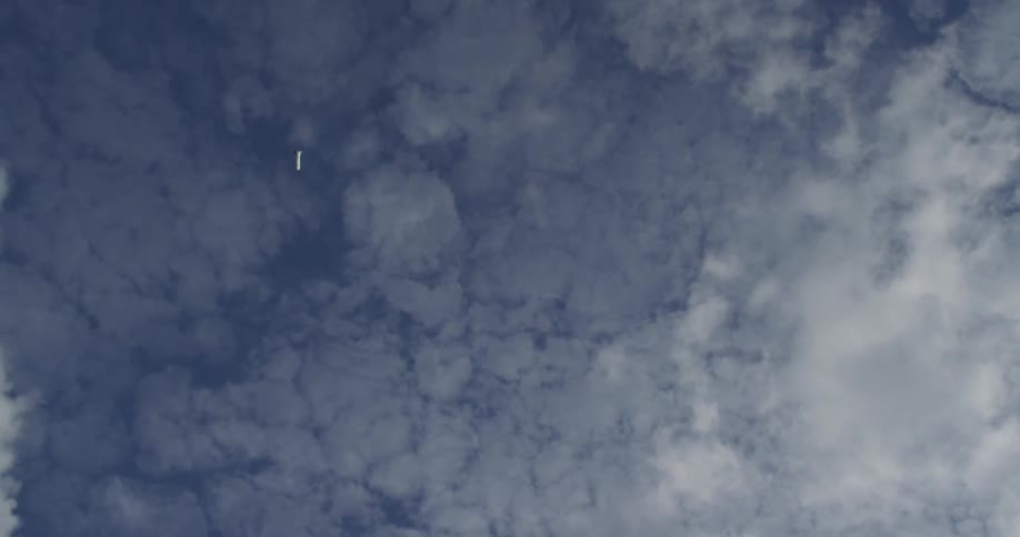 A boy launches toy rocket in to sky