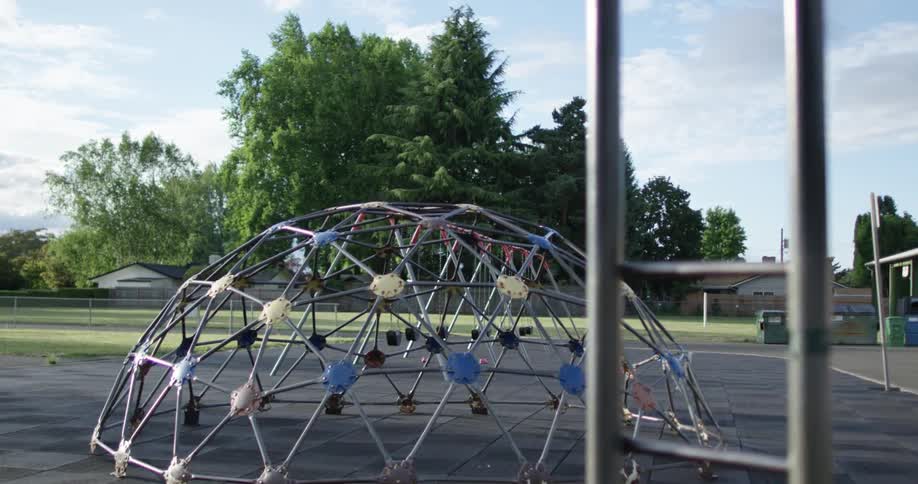 A jungle gym in a park sits empty