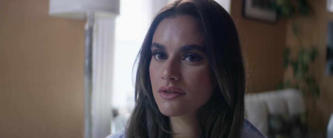A woman in a living room looks around