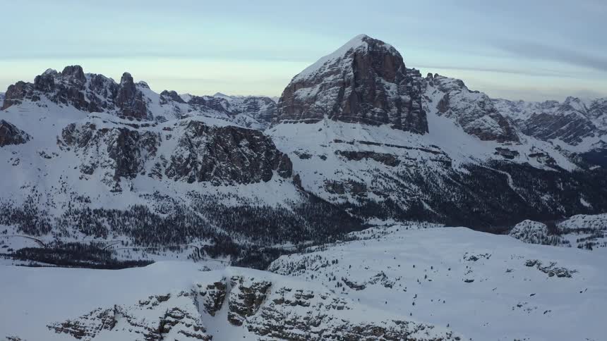 An aerial view of a mountain range covered in snow