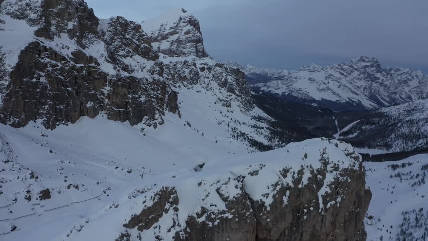 A thick blanket of snow covers a vast mountain range