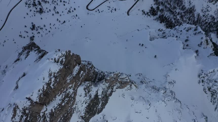 Aerial view of snow covered mountain peaks at morning