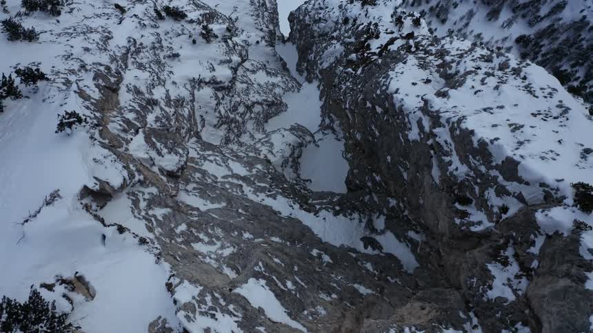 Snow on rock cliffs in the mountain wilderness
