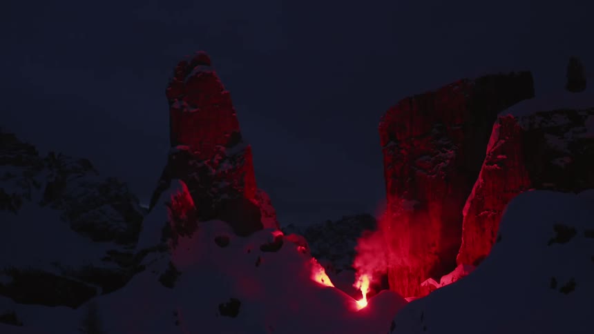 A fire is burning on the mountain top