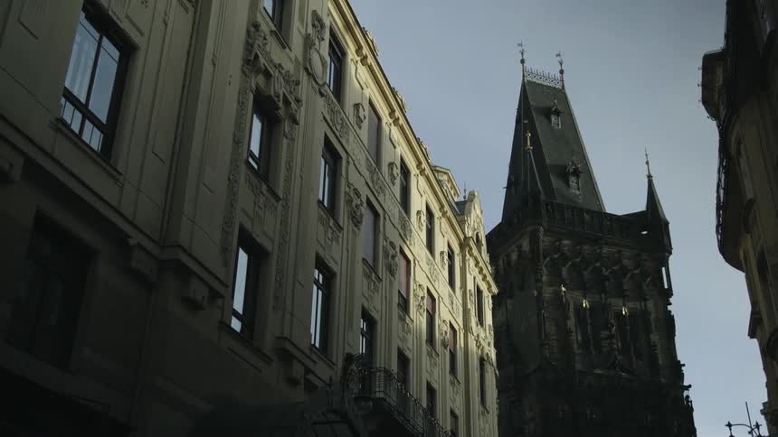 A towel sits on top of a building next to a historical apartment complex