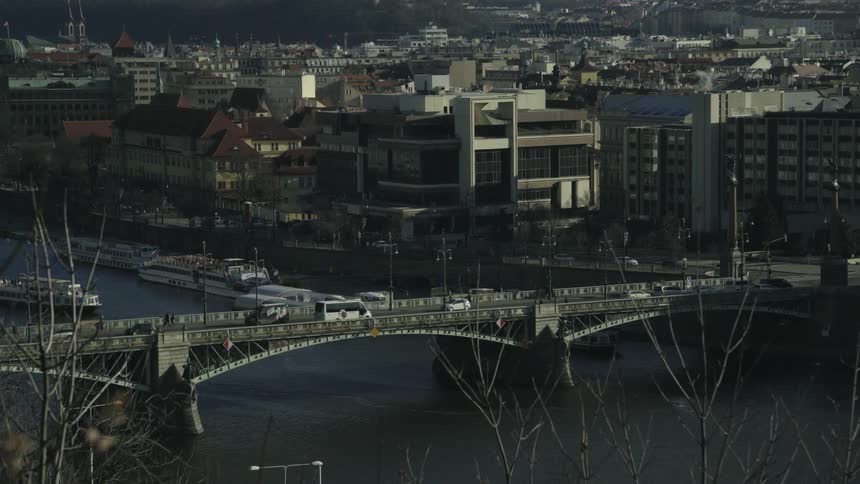 An aerial view of a bridge at the edge of a city
