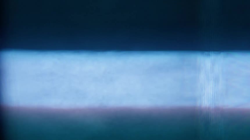 Close view of vertically scrolling static from an old style television