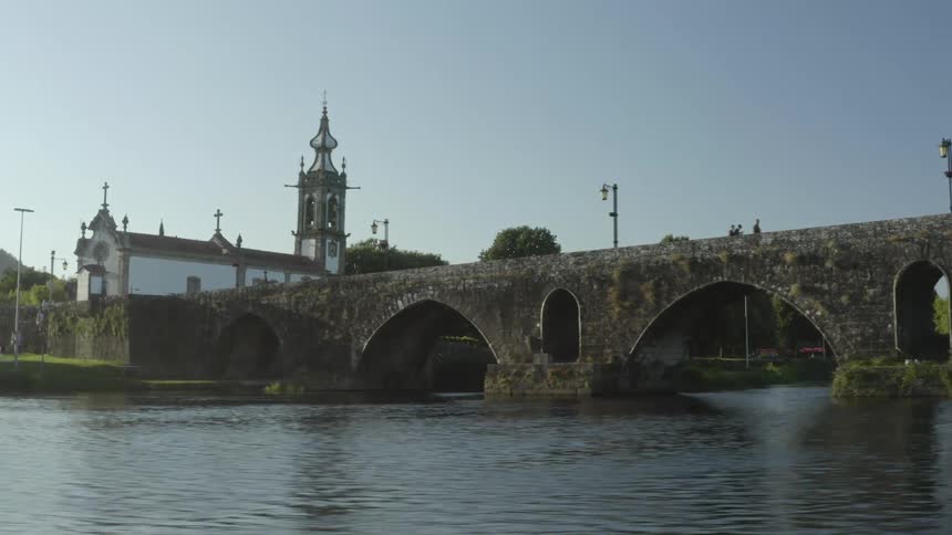 A view from a river of a bridge