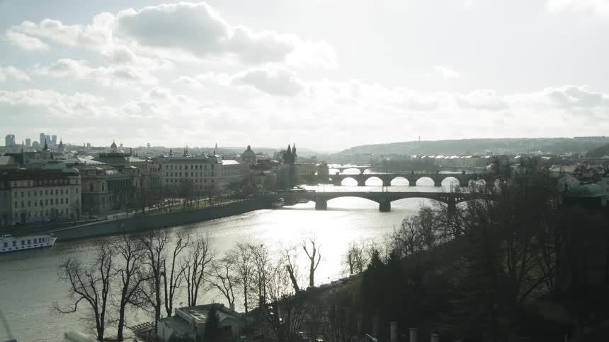 A pair of bridges spanning a river in a city during the day