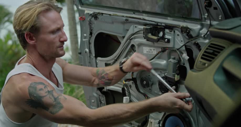 A man working on a car with a wrench