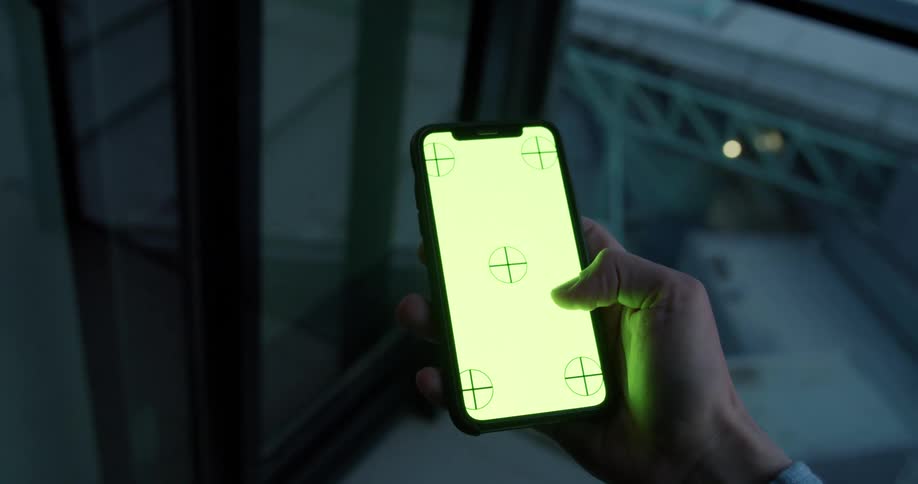 Someone is holding a phone in their right hand