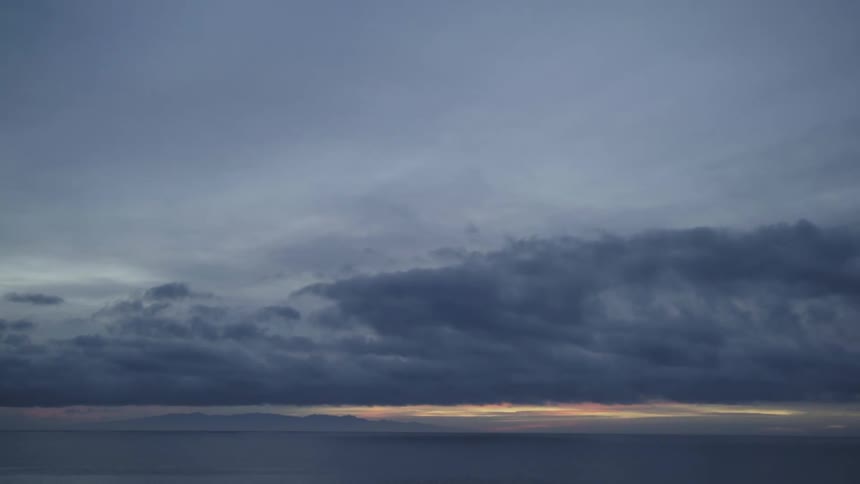 View of sunset with clouds seen from beach
