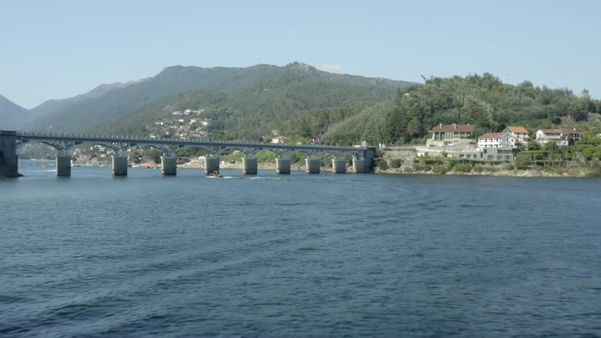 View of bridges and coastal town near the mountains under the blue sky