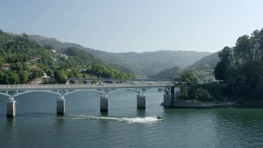 Vehicles travel over the two bridges