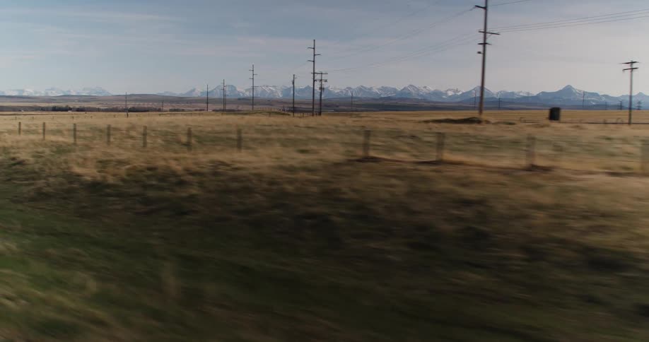 Transmission towers line a field in the countryside