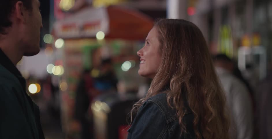 A man and woman talking at a carnival