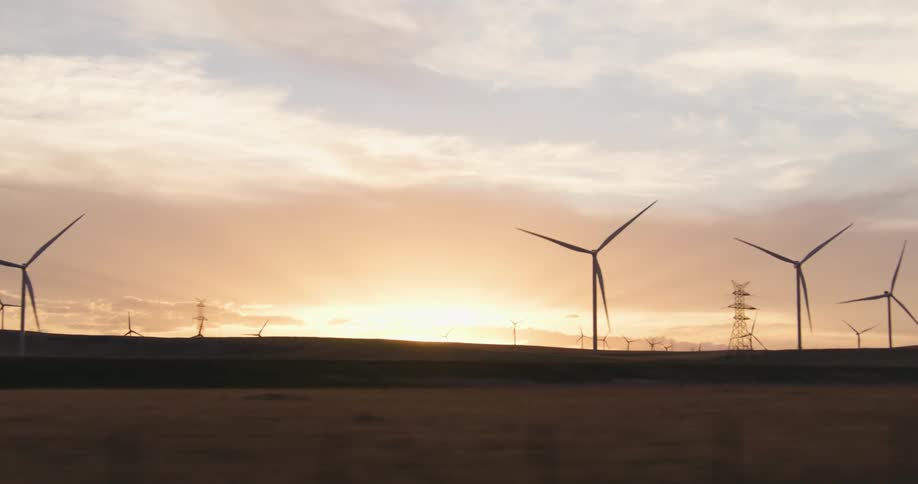 Wind turbines spin in a vast open field