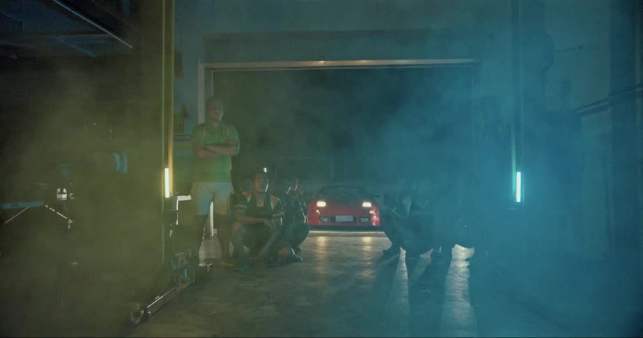 A group of people standing around in a garage