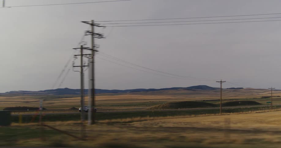 electric sports car driving down a road on the plains at morning