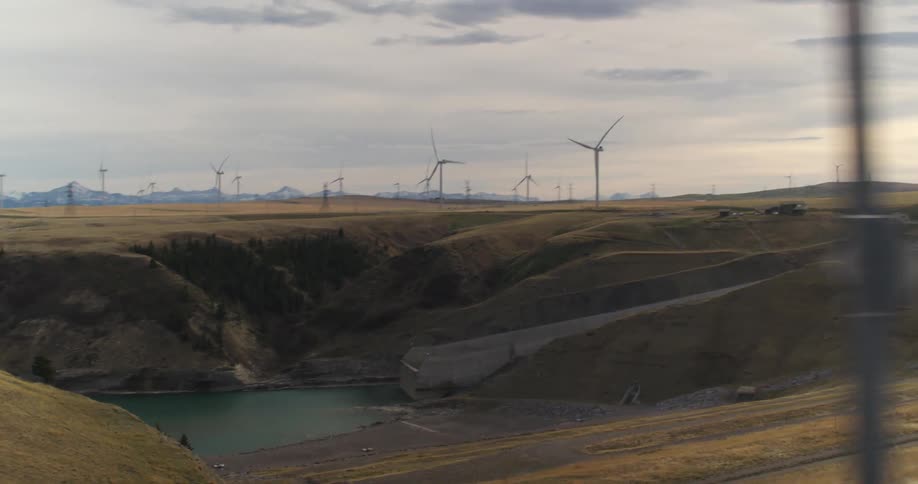 Wind turbines produce electricity on wind farm next to hydroelectric power