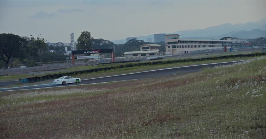 A person drifting a car around a track