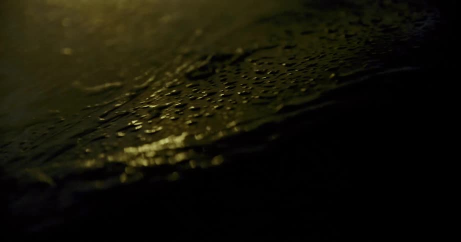 Water pours on the car at night
