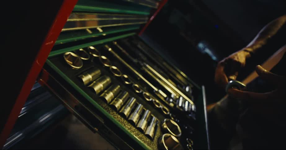 Man selects socket from toolbox fitting it onto socket wrench