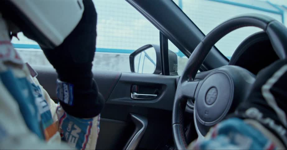 A view of a person driving a car on a race track