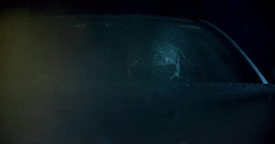 A person driving a race car at night