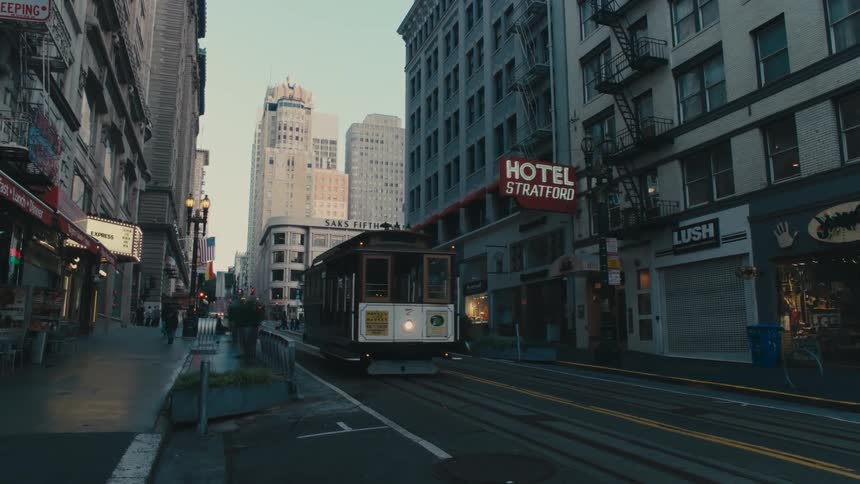 Tram car driving down the city street at morning