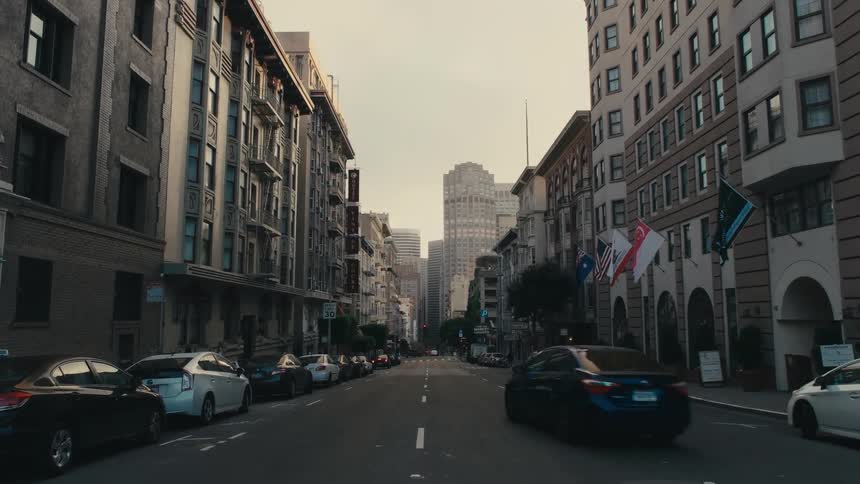 Black car driving down the road on the city downtown at morning