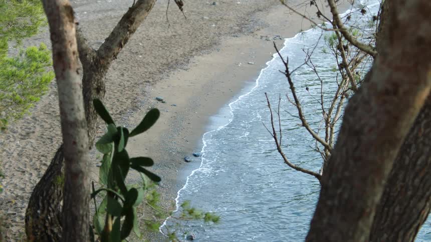An elevated view of an empty beach during the early evening