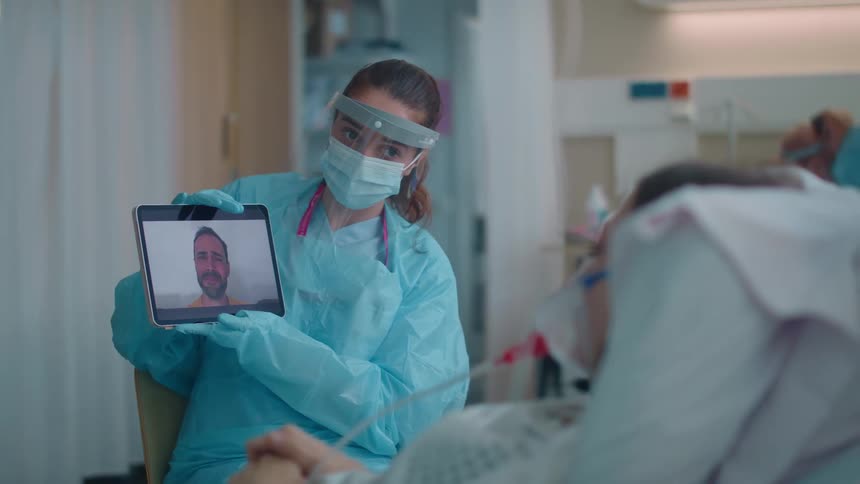 A woman talking to someone on a tablet