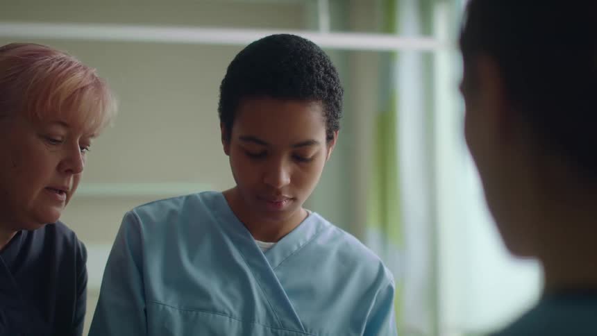 Young nurse receives training in a hospital room