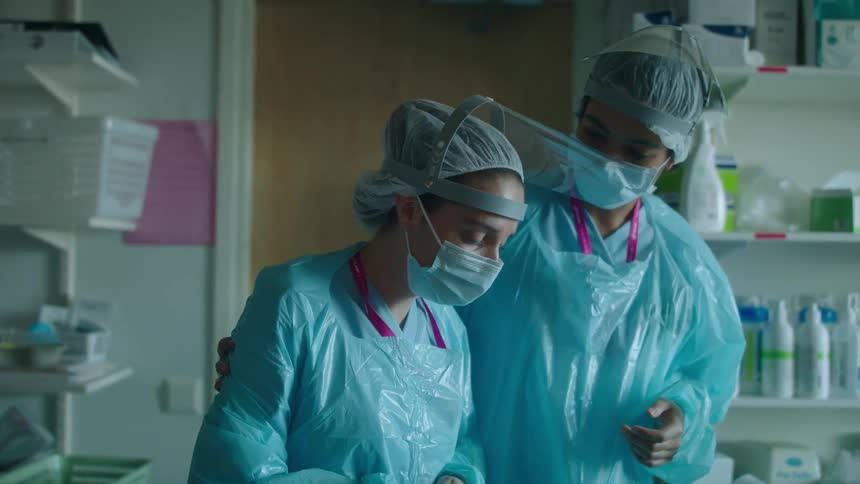 A woman is consoled in the hospital