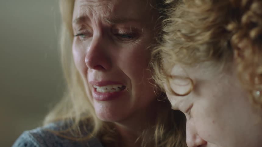 A mother and daughter hugging and crying