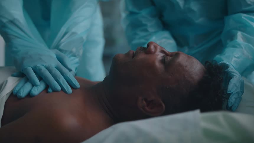 A man getting cpr done on him at a hospital